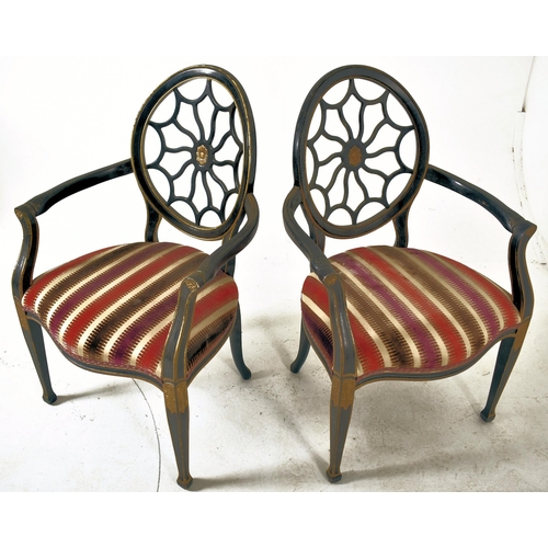 325 - A pair of Regency Revival ebonised & gilt painted spider web back armchairs. Each chair having a bal... 