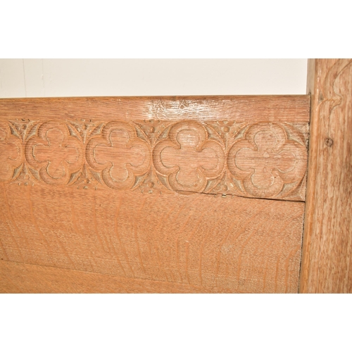 337 - Heal & Son, Ltd - A pair of Arts & Crafts early 20th century carved oak single beds. Each bed includ... 