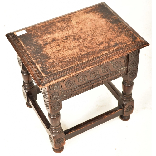 341 - A 17th century style carved oak lift top joint stool. The stool having a chamfered edge lift top ope... 