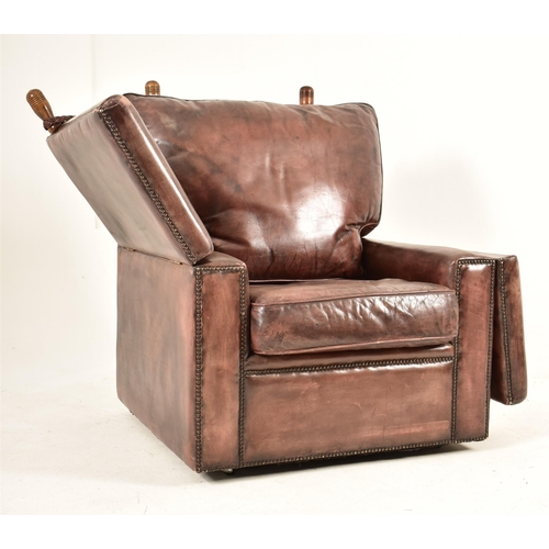 367 - A pair of Knole style brown leather drop-side armchairs. Each armchair having a straight back with w... 