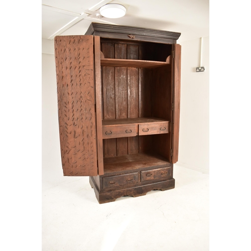 378 - An Indian inspired Sehhawati - Rajastan hardwood double door armoire wardrobe. The armoire having a ... 