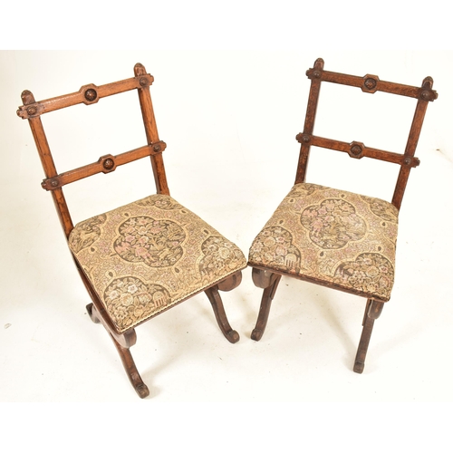 379 - A pair of late 19th century carved oak Gothic inspired Aesthetic Movement dining chairs. Each chair ... 