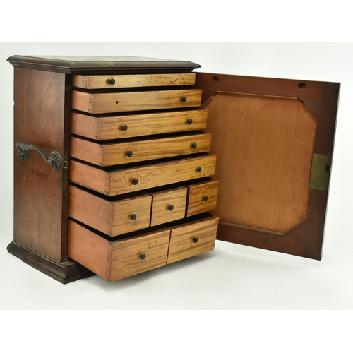 383 - An early 20th century mahogany watchmakers specimen chest cabinet. The cabinet having a chamfered fl... 