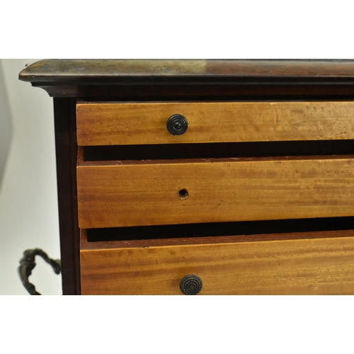 383 - An early 20th century mahogany watchmakers specimen chest cabinet. The cabinet having a chamfered fl... 