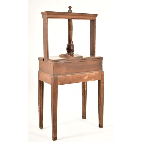 384 - A George III 18th century oak book press on table stand. The press having a large upright central wo... 