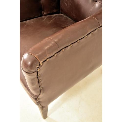 385 - A Victorian style 20th century brown leather button back Chesterfield armchair. The armchair having ... 