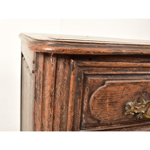 388 - A French 19th century oak commode / chest of drawers. The chest having a shaped top with chamfered e... 