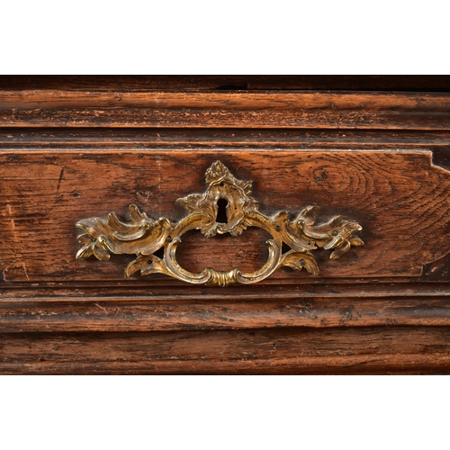 388 - A French 19th century oak commode / chest of drawers. The chest having a shaped top with chamfered e... 