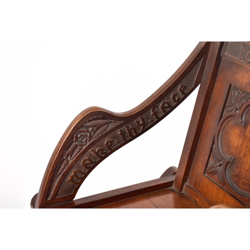 392 - A Victorian 19th century carved oak Glastonbury chair. The chair having a squared frame with shaped ... 