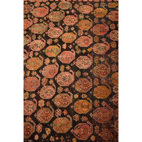 610 - A 19th century hand woven Persian Islamic Bidjar floor carpet rug. The rug having a central shaped m... 