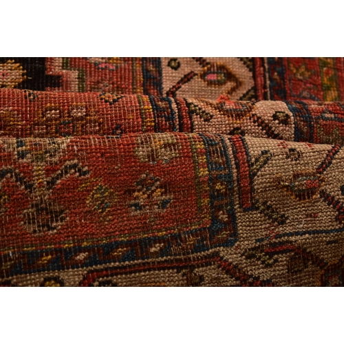 610 - A 19th century hand woven Persian Islamic Bidjar floor carpet rug. The rug having a central shaped m... 