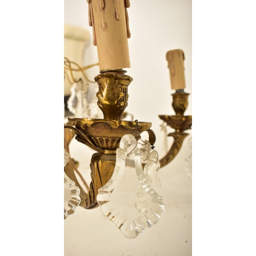 613 - A continental inspired early 20th century 1920s style gilded solid brass six arm ceiling chandelier.... 