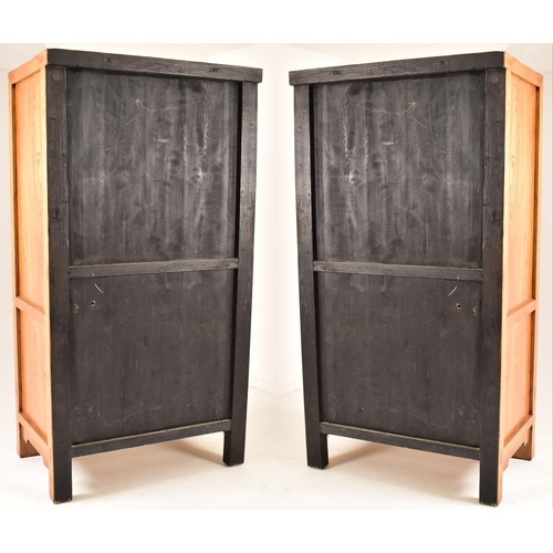 614 - A pair of Chinese Qing Dynasty elm inspired marriage two door wardrobes. Each having a straight top ... 