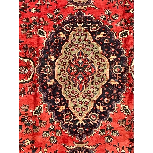 369 - An early 20th century North East Persian Islamic Meshed floor carpet rug. The rug having a central s... 