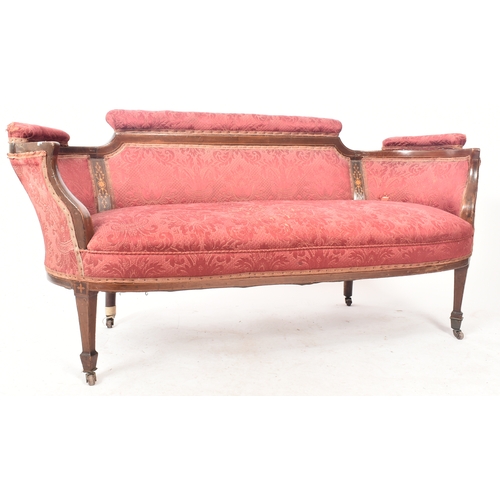 412 - An Edwardian mahogany inlaid framed two seater salon sofa / settee. The sofa having a shaped padded ... 