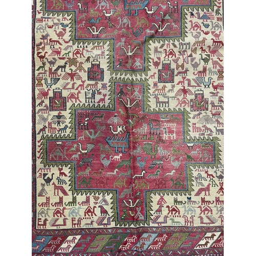 421 - A early 20th century North East Persian Islamic Sumak Kilim floor carpet rug. The rug having two cen... 