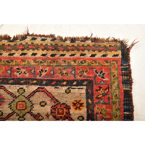 610 - A 19th century hand woven Persian Islamic Bidjar floor carpet rug. The rug having a central shaped m... 