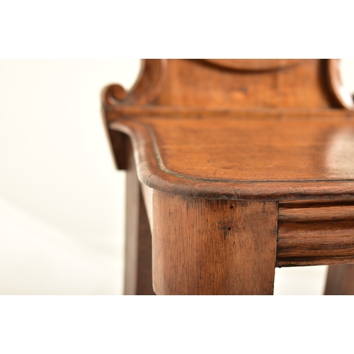 443 - A pair of Victorian 19th century carved oak round back hall chairs. Each chair having a pierced roun... 