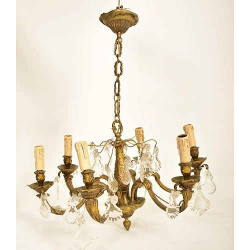 613 - A continental inspired early 20th century 1920s style gilded solid brass six arm ceiling chandelier.... 