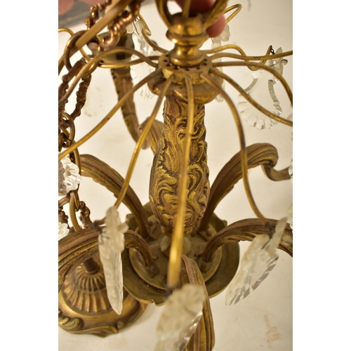 613 - A continental inspired early 20th century 1920s style gilded solid brass six arm ceiling chandelier.... 