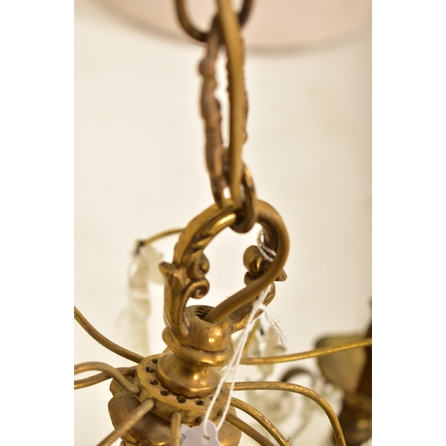 613 - A continental inspired early 20th century 1920s style gilded solid brass six arm ceiling chandelier.... 