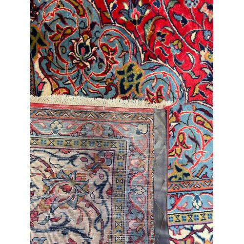 447 - A 20th century North West Persian Islamic Sarouk floor carpet rug. The rug having a central red pane... 