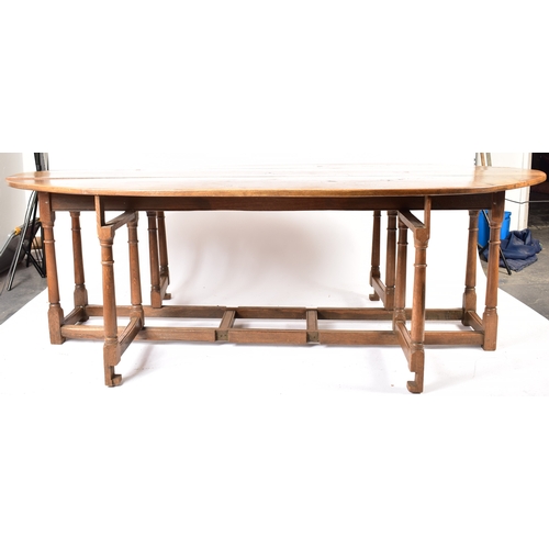 448 - An Irish manner large peg jointed solid oak wake dining table. The large table raised on block and t... 