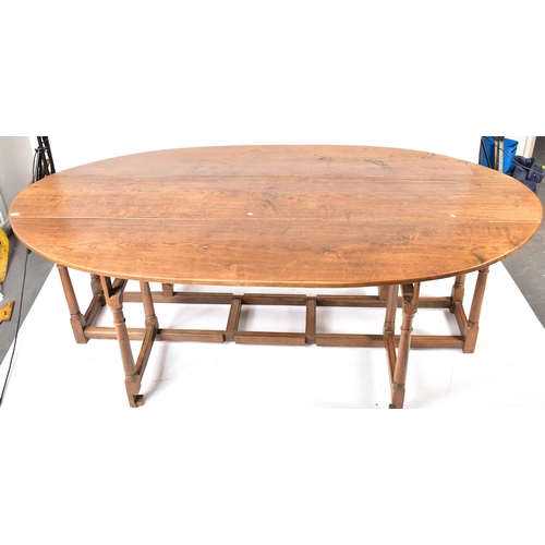 448 - An Irish manner large peg jointed solid oak wake dining table. The large table raised on block and t... 