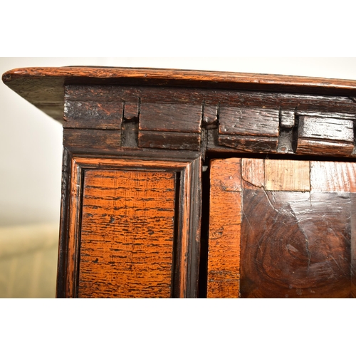 252 - A 17th century Queen Anne oak and walnut chest of drawers. The chest having a bank of four short and... 