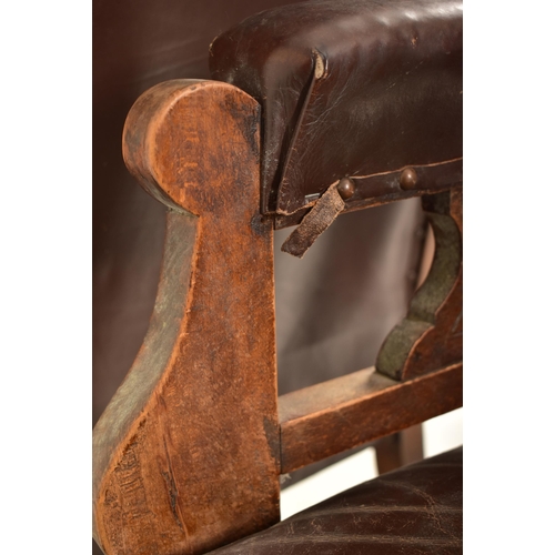 257 - A near matched pair of late Victorian carved oak & brown leather ladies & gentleman's armchairs. The... 