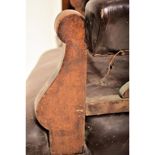 257 - A near matched pair of late Victorian carved oak & brown leather ladies & gentleman's armchairs. The... 