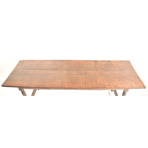 259 - A 17th century oak commonwealth refectory dining table. The table having a rectangular straight top ... 