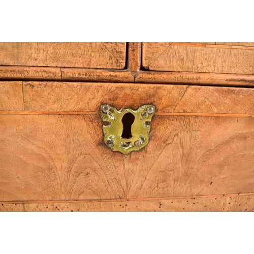 268 - A 17th century Queen Anne walnut chest of drawers. The chest having a crossbanded top with geometric... 