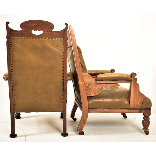 277 - A near matched pair of late Victorian carved oak & leather gentleman's library armchairs. The lot co... 