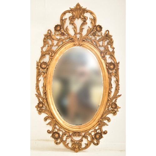 278 - A French inspired early 20th century carved gilt wood oval wall hanging mirror in the Napoleon III m... 