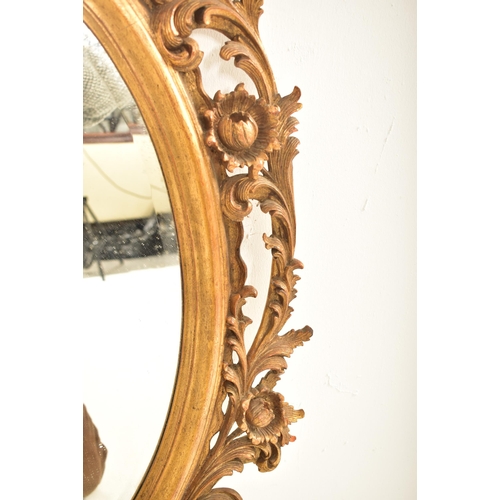 278 - A French inspired early 20th century carved gilt wood oval wall hanging mirror in the Napoleon III m... 