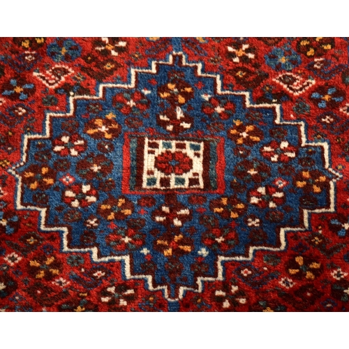 284 - A large 20th century Azimi Persian hand knotted floor carpet rug. The rug having a central fielded p... 