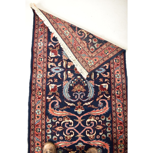 289 - A 20th century 1950s Lilihan Persian floor carpet rug runner. The runner having a cobalt blue ground... 