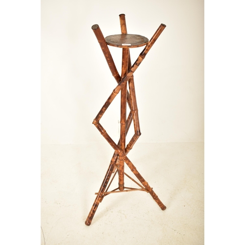 303 - A Victorian 19th century Aesthetic movement bamboo plant stand / jardinière. The torchere of bamboo ... 