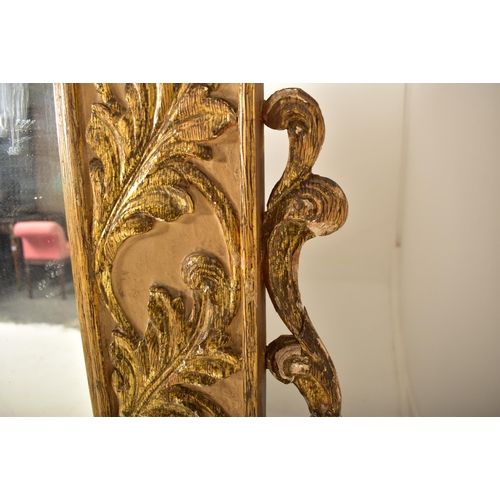 500 - A large continental 19th century Italian Rococo inspired gilt wood wall mirror. The mirror having an... 