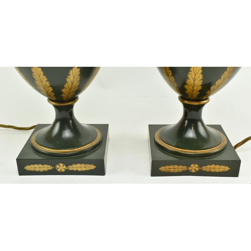 304 - A pair of Regency style toleware painted metal desk table lamps in the shape of handled urns. Each l... 