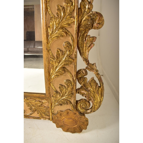 500 - A large continental 19th century Italian Rococo inspired gilt wood wall mirror. The mirror having an... 