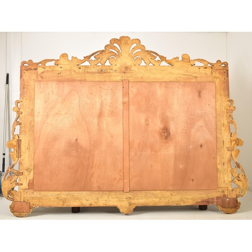 500 - A large continental 19th century Italian Rococo inspired gilt wood wall mirror. The mirror having an... 