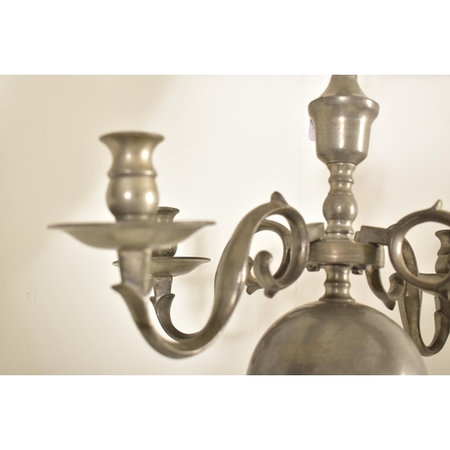 305 - A mid 19th century Dutch style four branch pewter chandelier. The chandelier with numbered detachabl... 