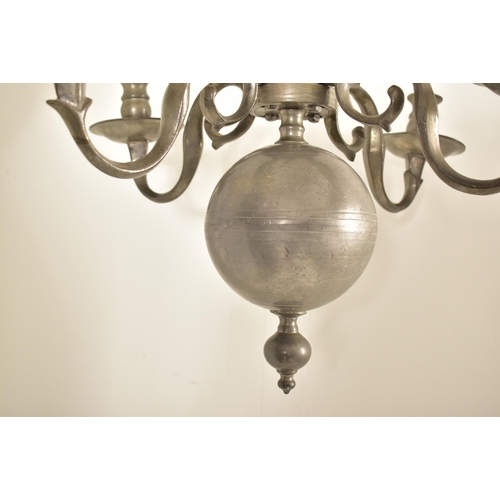 305 - A mid 19th century Dutch style four branch pewter chandelier. The chandelier with numbered detachabl... 