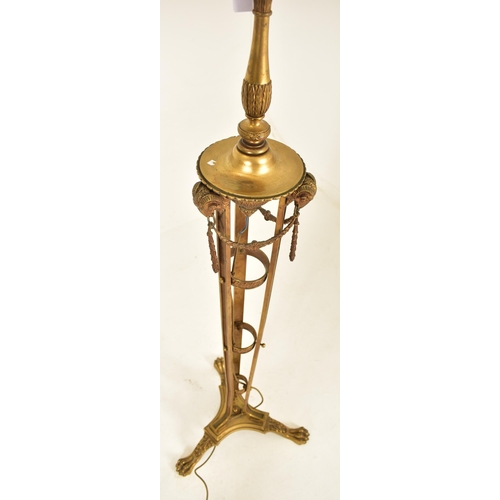 307 - A Neo-classical inspired brassed metal floor standard lamp. The lamp having three adjustable heads o... 