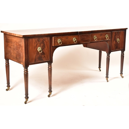 504 - A late 18th century George III mahogany credenza – sideboard. The credenza being raised on turned an... 