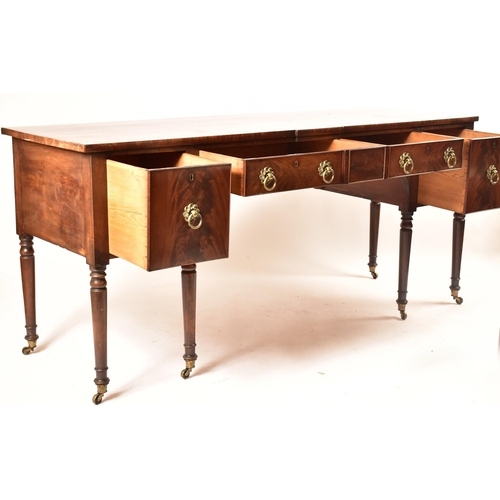 504 - A late 18th century George III mahogany credenza – sideboard. The credenza being raised on turned an... 