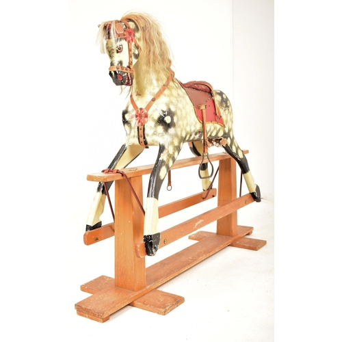 314 - A 1920's carved wood hand painted rocking horse on swing base in the manner of Line Brothers. The ho... 