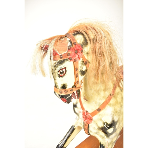 314 - A 1920's carved wood hand painted rocking horse on swing base in the manner of Line Brothers. The ho... 